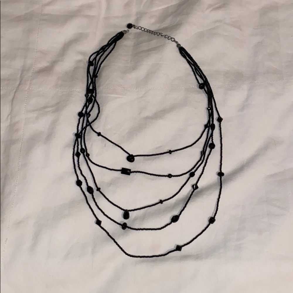 Multi layered black necklace with black beads.